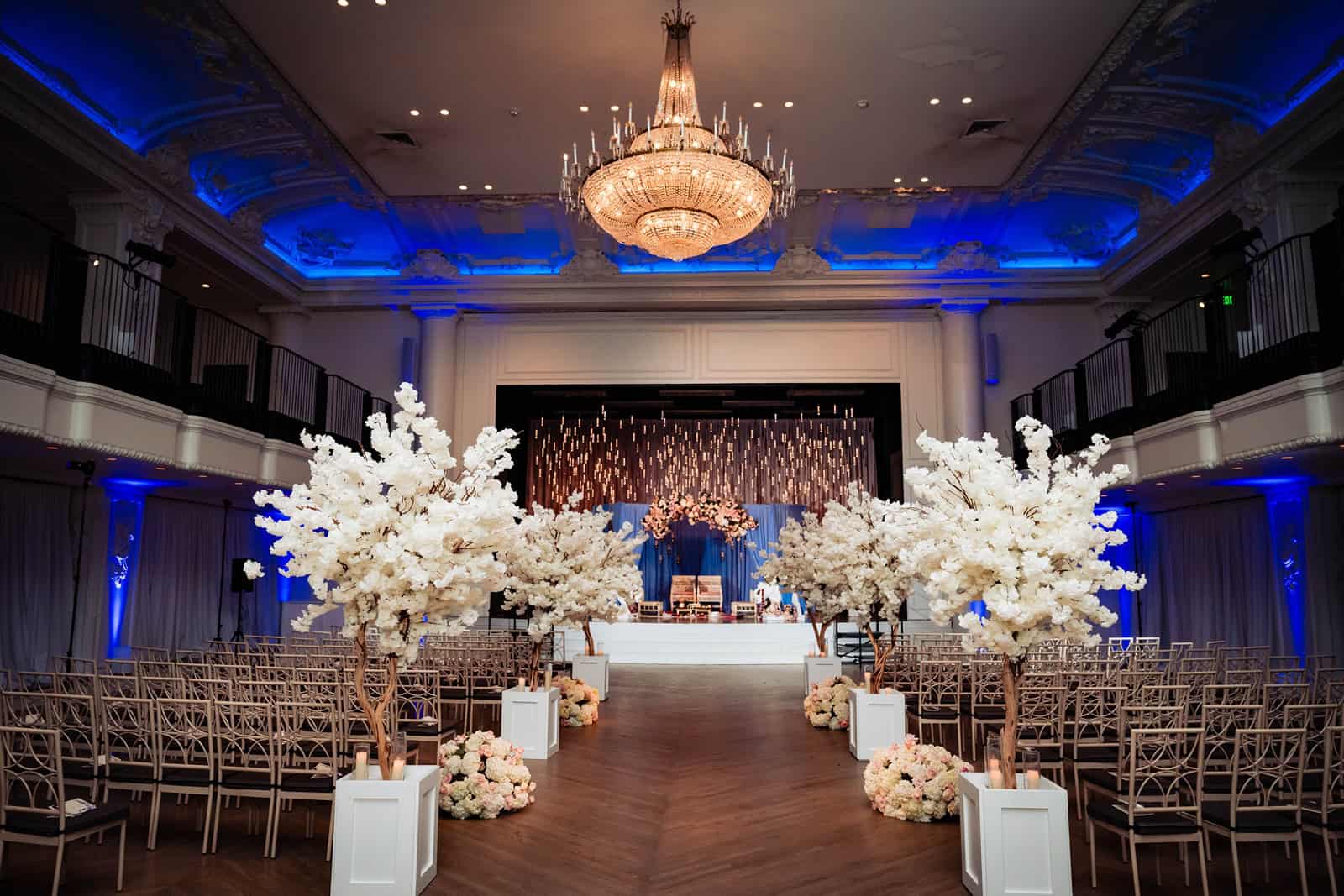 Large white flower arrangements at the South Asian wedding ceremony venue